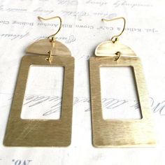 This is a pair of large geometric earrings. Bohemian style brass shapes dangle from simple gold plate ear wires. These statement earrings measure approx 2 1/4 inches from the top of the ear wire to the bottom of the charms. Your lovely item will arrive in a cute beige cotton drawstring gift bag with a gift tag. Perfect for gift giving or a fun little treat for yourself. This jewelry bag can be re-purposed to hold your jewelry while traveling, use it in your purse as a makeup bag or you can put s Rectangular Gold Brass Jewelry, Gold Geometric Earrings For Everyday, Rectangular Brass Earrings, Rectangular Brass Jewelry In Gold-tone, Gold-tone Brass Rectangular Jewelry, Rectangular Metal Earrings For Everyday, Rectangular Gold-tone Brass Jewelry, Gold Brass Rectangular Earrings, Modern Gold Oblong Earrings