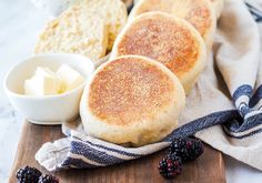 some bread and berries are on a cutting board