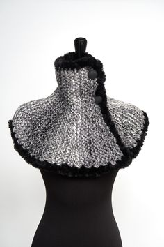 If you've been looking for something unique and are tired of wearing scarves in a cold weather, then this is a great alternative for you. You can wear this capelet under or over your favorite coat or even with a dress for a unique look. Just look at the pictures to get some ideas how you can wear this unique garment. I knitted this cowl capelet from a soft wool/acrylic/alpaca yarn and embellished with faux fur trim and three buttons. Measurements: from neck to bottom - approx. 13" (34 cm) More capelets cowls here - https://www.etsy.com/shop/KnitsomeStudio?ref=seller-platform-mcnav§ion_id=10514179 and here - https://www.etsy.com/shop/KnitsomeStudio?ref=seller-platform-mcnav§ion_id=25373486 Don't forget to check out my other items! There are many more in my shop -- http://www.etsy.com/shop/k Black Winter Scarves, Warm Black Winter Scarf, Black Winter Scarves For Cold Weather, Black Scarves For Cold Weather, One Size, Black Knitted Scarves For Winter, Black Knitted Winter Scarf, Black Knitted Scarf For Winter, Winter Knit Scarves, Knit Winter Scarves