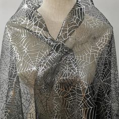 a black and white shawl on a mannequin