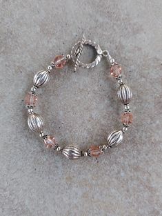 "Sterling Silver and Swarovski Crystal Handmade Bracelet, 7.25\" all beads are Bali sterling silver including toggle clasp. Swarovski crystals are light peach 8mm bicone.  Any of my handmade jewelry can be adjusted in size, just message me under the listing. Check out my other jewelry at https://loveofjewelryshop.etsy.com" Bali Silver, Jewelry Making Bracelet, Swarovski Crystal Bracelet, Swarovski Bracelet, Chunky Bracelets, Light Peach, Swarovski Jewelry, Handmade Bracelet, Balinese