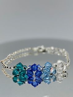 Hand Beaded Swarovski Crystal Bracelet #Swarovski #blue #bicone #bracelet #crystal Blue Crystal Bracelet With Colorful Beads As Gift, Elegant Blue Crystal Bracelet With Polished Beads, Blue Crystal Bracelet With Large Adjustable Beads, Handmade Blue Crystal Wedding Bracelet, Hand-strung Blue Crystal Bracelet As Gift, Hand Beaded Jewelry, Diy Jewelry Unique, Swarovski Crystal Bracelet, Bracelets Handmade Beaded