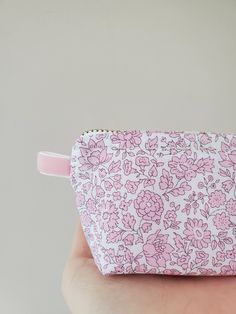 "100% Cotton. Lightweight. From the world famous Liberty Fabrics with a silk-like touch, unique print quality and striking color vibrancy. This mini pouch is great size for a couple of small items. Size is 3.5\"W / 2.3\"H / 1.2\"D (9cm / 6cm / 3cm) Flat bottom shape. Fabric is Liberty of London Tana Lawn. The pouch opens with golden color zipper.(High quality YKK zipper) It comes with a velvet ribbon on one side.(color is pale pink) Lined inside with pretty baby-pink color cotton. Please, Hand w Pink Zipper Pouch Pencil Case, Pink Pencil Case With Removable Pouch, Pink Pencil Case With Zipper Closure As Gift, Pink Cosmetic Bag As Gift, Pink Cosmetic Bag For Gift, Pink Feminine Travel Pouch, Feminine Pink Travel Pouch, Pink Rectangular Feminine Pouch, Feminine Pink Rectangular Pouch