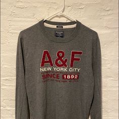 Abercrombie & Fitch “Muscle” Long Sleeve T Shirt Size M. Never Worn, No Tags Gray Graphic Tee For Fall, Fall Sporty Tops With Graphic Print, Sporty Graphic Print Tops For Fall, Fall Long Sleeve Tops With Logo Print, Long Sleeve Tops With Logo Print For Fall, Winter Cotton Tops With Logo Print, Fall Cotton Crew Top, Cotton Crew Top For Fall, Gray Long Sleeve Top With Logo Print