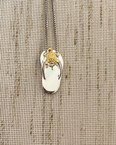 ".925 Sterling Silver w/ 14K Yellow Gold Hawaiian Turtle Honu Slipper Flip-Flop Necklace. The length is 20MM, about 3/4\". The highly-detailed Honu is 6.5MM. FREE Italian Sterling Silver Box Chain Included in your choice of length. The Highly-reflective Sterling Silver finish is stunning, durable & will shine for years to come. This popular design is super adorable in person. --The Hawaiian Turtle is the only indigenous reptile in the Islands. Symbols of the Turtle are often exchanged to sig Sterling Silver Pendant Necklace For Beach, Sterling Silver Pendant Jewelry For Beach, Silver Engraved Necklace For Beach, Engraved Pendant Necklace For Beach, Gold Sterling Silver Jewelry For Summer, Yellow Gold Pendant Jewelry For The Beach, Silver Summer Jewelry For Anniversary, Silver Jewelry For Summer Anniversary, Beach Pendant Jewelry With Engraving