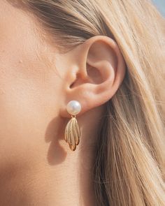 Indulge in luxury with our Chérie Drop Studs. These elegant earrings feature lustrous pearls, hand-selected for their exquisite beauty. The delicate drop design adds a touch of sophistication to any outfit, making these studs the perfect statement piece for any occasion. Material: 14K gold or rhodium plated brass, shell pearls Features: 1.25" drop, 0.3" stud, 0.95" charm, 9mm pearls, Lead & Nickel free, post back Classic Metal Earrings With Pearl Charm, Classic Metal Pearl Earrings With Pearl Charm, Elegant Metal Jewelry With Pearl Pendant, Elegant Pearl White Metal Pearl Earrings, Pearl Drop Earrings With Charm For Evening, Elegant Metal Earrings With Pearl Pendant, Feminine Pearl White Earrings With Pearl Drop, Elegant Metal Pearl Drop Earrings, Classic Metal Jewelry With Pearl Drop