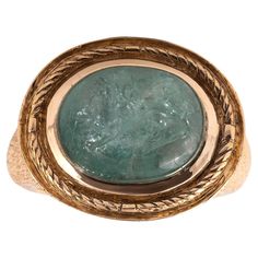 The oval-shaped emerald carved to depict a figure of a griffin , in a closed-back setting, 18th century composite, ring size 8 1/4 Weight : 19,7gr. Size of bezel : 15mm x 21mm Byzantine Oval Gemstone Ring, Oval Byzantine Gemstone Ring, Antique Oval Emerald Ring, Antique Emerald Ring Oval Cabochon, Antique Emerald Ring In Gold With Oval Cabochon, Antique Gold Emerald Ring With Oval Cabochon, Antique Emerald Ring With Oval Cabochon, Ancient Oval Engraved Jewelry, Antique Oval Engraved Emerald Ring