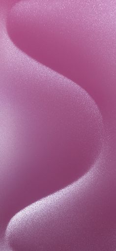 a close up view of the surface of a pink wallpaper with smooth lines on it