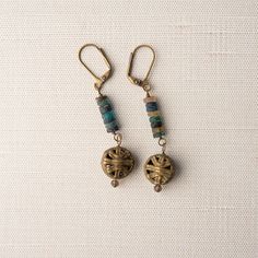 Boho Earrings with Brass Cage Beads Express your unique style! Bold Composition of brass cage beads and a stack of recycled glass Ashanti beads with brass latch-back closures. Handmade and one-of-a-kind. GIFTABLE A jewelry gift pouch is included. The pouch will differ from the one photographed. A representative sample is shown. SIZE 2" READY TO SHIP Each piece is a handcrafted one-of-a-kind piece. Our pictures represent a close color palette of the glazed stoneware and semiprecious stones as well as the typical shape and size variations.  The jewelry piece you receive will be a unique, one-of-a-kind piece, but will not be an exact duplication of the photograph. COORDINATING JEWELRY Two Strand Necklace... https://www.etsy.com/listing/1728690589/necklace-turquoise-blue-ashanti-bead-and?ref=l Earthy Bronze Dangle Jewelry, Festival Brass Beaded Earrings With Ear Wire, Artisan Brass Jewelry With Round Beads, Bohemian Bronze Earrings With Round Beads, Beaded Brass Dangle Earrings, Brass Beaded Earrings With Round Beads For Festival, Brass Beaded Drop Earrings For Pierced Ears, Bronze Dangling Beads Earrings For Gift, Bronze Earrings With Dangling Beads For Gift