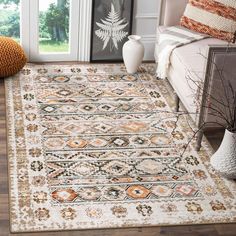 a living room area with a large rug on the floor