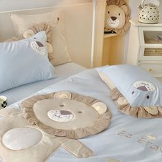 a child's bed with stuffed animals on the comforter and pillowcases