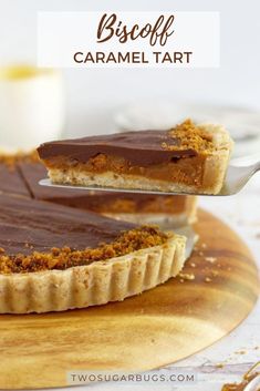 a chocolate caramel tart on a wooden plate