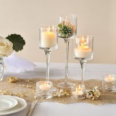 a table with candles and flowers on it