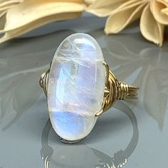 Rainbow Moonstone Oval Statement Ring-Sterling Silver, 14k Yellow or Rose Gold Filled Wire Wrapped Ring -Custom Size (full, .25, .5, .75) by SimplyCharmed21 on Etsy Celestial Opal Birthstone Ring In Oval Shape, Celestial Oval Jewelry With Natural Stones, Celestial Oval Gemstone Jewelry, Celestial Style Oval Jewelry With Natural Stones, Celestial Jewelry With Oval Natural Stones, Celestial Oval Opal Birthstone Ring, Celestial Oval Cabochon Rings, Adjustable Oval Spiritual Rings, Spiritual Oval Crystal Ring With Natural Stones