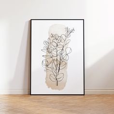 a black and white drawing on a wall next to a wooden floor