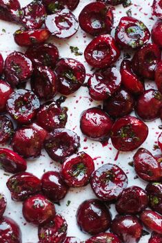 cherries are drizzled with white sauce and sprinkles