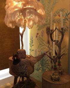 a lamp that is on top of a table next to a turkey figurine