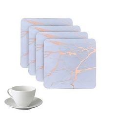 marbled coasters with white coffee cup and saucer next to eachother