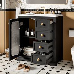 a bathroom with a sink, mirror and black cabinet in the middle of the floor