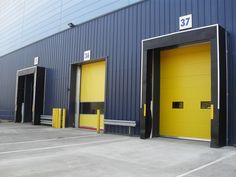 two yellow doors in front of a blue building