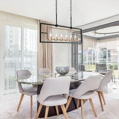 a dining room table with chairs and a chandelier