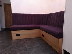 a corner couch sitting on top of a tiled floor