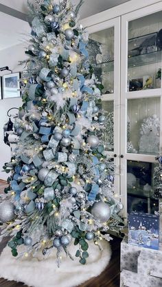 a blue and silver christmas tree in a living room