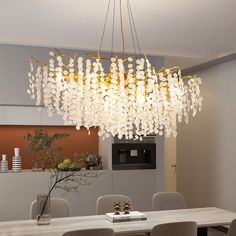 a chandelier hanging over a dining room table