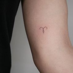 a woman's arm with a small tattoo on the left side of her arm