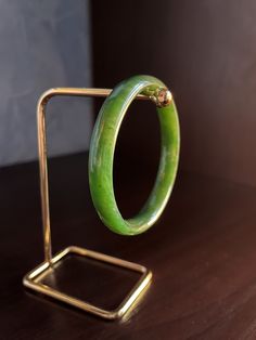 Inner diameter: 65 mm (2.56 inches) Width: 11 mm ( 0.43 inches) Thickness: 8 mm (0,31 inches) Weight: 45 g (1.59 ounces) Quality stone: Modeu Colour: ivory and olive Mineral deposits: Eastern Sayan (Siberia) The bracelet (Jade Bangles) is made of solid natural Siberian nephrite. Like all our products, it is handmade with soul and immense love for the stone. This is an author's work from the workshop "SIBERICA". Hand-polished to the highest quality.  Handcrafted nephrite jewelry is a wonderful ad Round Spiritual Collectible Bracelets, Carved Jade Bangle Bracelet, Green Carved Bracelet As A Gift, Green Carved Bracelets As Gift, Green Carved Bracelet For Gift, Spiritual Green Bangle Bracelet, Spiritual Carved Bangle Bracelets, Green Carved Round Bangle, Carved Jade Round Bracelets