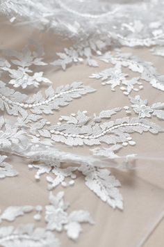 white lace on fabric with flowers and leaves