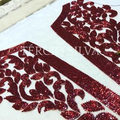 red sequins on white fabric with floral design