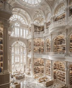 the interior of a large library with many bookshelves and tables on each floor