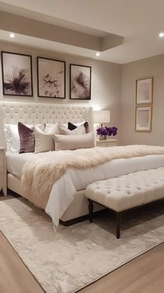 a white bed sitting in a bedroom on top of a hard wood floor