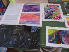 art work being displayed on a table with papers