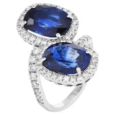 Discover the exquisite beauty of this Vintage Sapphire and Diamond Halo Bypass Engagement Ring. Perfect for those who cherish sophisticated elegance with a splash of vibrant color, this ring is an unforgettable choice for a proposal. Luxurious jewelry design. This ring features two natural Virbant blue oval sapphires, both sapphires are from Madagascar, totaling approximately 10.88 carats, encircled by a halo of 61 natural round diamonds. Sapphire measures approximately 11.77mm x 9.16mm x 5.54mm and weighs 5.29 carats  the other measures 11.9mm x 8.95mmx 5.55mm and 5.59 carats each surrounded by round diamonds, approximately 1.83 carats VS clarity, G-H color, set in premium platinum. The beautiful bypass style on an accent band is a statement ring, sized at 6.75(sizable). Two GIA Lab Repor Bypass Engagement Ring, Luxurious Jewelry, Vintage Sapphire, Gem Stone, Diamond Halo, Sapphire Diamond, Color Set, Cocktail Rings, Halo Diamond