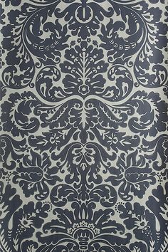 a blue and white wallpaper with an ornate design on it's side,