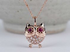 lucky Owl, Diamond Daily pendant Condition: Brand New Style: Diamond Necklace, pendant Side stones : Natural white diamond  (round, 1.2mmx 12 pcs)  natural ruby ( round, 2,2mm x 2) Metal Purity: 10 k ,14 k 18k Solid Rose gold,yellow gold  Comes in a nice jewelry gift box. 100 % handmade in CANADA. Please Contact Us if you have any questions . **Items might appear larger in photos.  Please use a ruler to check dimensions and size before purchase.** White Gold Ruby Jewelry Gift, Single Cut Diamond Pendant Jewelry Gift, Single Cut Diamond Pendant As A Gift, Pendant Jewelry With Single Cut Diamonds For Gift, Ruby Pendant Jewelry Gift, Rose Gold Ruby Jewelry With Diamond Accents, Diamond White Jewelry With Diamond Eyes Pendant, Diamond White Pendant Jewelry With Diamond Eyes, Diamond Charm Necklace As Gift