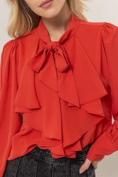 Get ready to add some playful flair to your wardrobe with our Ruffles Blouse! Featuring long balloon sleeves with buttoned cuffs, a pretty tie-neck, and gentle ruffles at the front, this blouse brings fluttery movement to any outfit. The button-down bodice offers a classic fit and ends with a rounded hem for a stylish touch. 100% Polyester Office Button-up Blouse With Ruffles, Casual Ruffle Button-up Blouse, Elegant Ruffled V-neck Blouse, Cotton Ruffle Button-up Blouse, Feminine Off-white Blouse With Ruffles, Long Balloons, Sweater Collection, Tie Blouse, Neck Ruffle