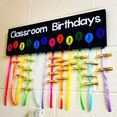 a classroom birthday sign hanging on the wall with toothbrushes attached to it's hooks