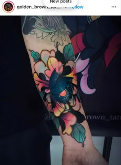 a person with a colorful tattoo on their arm and wrist, holding up a flower