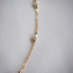 This pearl satellite necklace is the perfect layering piece! Dainty freshwater pearls on a 14K gold-filled chain. Stack with other necklaces or simply wear it alone, this necklace will shine either way!  Necklace length: 14", 16", 18", 20", 22" Extender length (optional): 2" Pearl size: 4mm ➤【 PLEASE READ 】➤ ✿ IMPORTANT ✿ Due to the organic nature of freshwater pearls, each pearl will differ slightly in size and shape and may feature small marks, white lines/spots, and/or dimples. Their beauty lies in their individuality! Please verify all measurements before placing an order. ✿ PROCESSING TIME ✿ Please allow 1-3 business days to handmake your jewelry before shipping out! ✿ WHAT IS GOLD-FILLED? ✿ Gold-filled jewelry is an excellent alternative to solid gold. It is a thick layer of gold tha Delicate Pearl Necklace With Satellite Chain, Pearl Satellite Chain Necklace As Gift, Pearl Necklace With Satellite Chain As Gift, Dainty 14k Gold-filled Yellow Gold Pearl Necklace, Gold Pearl Necklace With Satellite Chain In Dainty Style, Pearl Necklace Layering, Chain Stack, Satellite Necklace, Organic Nature