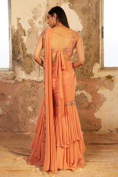 Shop for Shloka Khialani Peach Georgette Serena Pre-draped Saree With Blouse for Women Online at Aza Fashions Elegant Pre-draped Saree For Festivals, Elegant Draped Semi-stitched Sharara, Elegant Draped Silk Sharara, Elegant Draped Georgette Sharara, Elegant Silk Sharara With Draped Style, Pre-draped Floor-length Saree With Zari Work, Elegant Draped Sharara For Diwali, Elegant Draped Cutdana Sharara, Silk Draped Sharara For Wedding