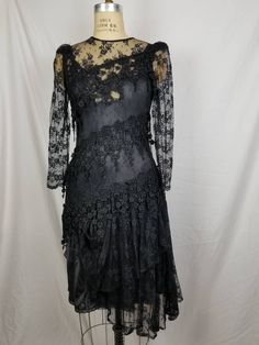 Good vintage condition Black lace Lace slip underneath 34 bust 32 waist 38 hip Has some stretch Sleeve 24 15 shoulders Gothic Fitted Dress With Lace Patchwork, Lace Dress For Evening, Sheer Fitted Gothic Dress, Evening Dress With Lace Patchwork And Fitted Bodice, Black Sheer Lace Evening Dress, Sheer Lace Evening Dress, Black Sheer Evening Dress With Fitted Bodice, Fitted Scalloped Lace Evening Dress, Black Evening Dress With Sheer Fitted Bodice