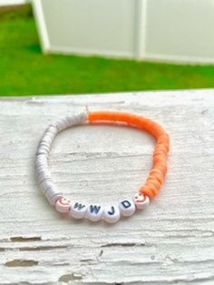 WWJD orange and white bracelet Personalized White Wristband Bracelet, Casual Handmade Orange Friendship Bracelets, Casual Handmade White Friendship Bracelets, Casual White Handmade Friendship Bracelets, Handmade Orange Casual Friendship Bracelet, Casual Handmade Orange Friendship Bracelet, Casual Handmade White Friendship Bracelet, Casual White Bracelets For Friendship, Personalized Orange Beaded Bracelets For Friendship