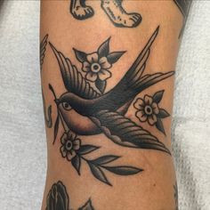 a bird with flowers on it's leg and an arrow in the middle is shown