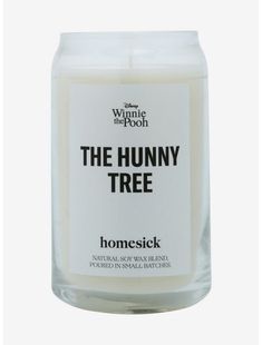 a white candle with the words, the hummy tree on it's front