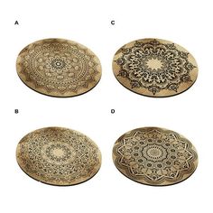 four decorative wooden plates with designs on them