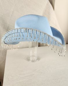 Stand out from the herd with our Glam Cowgirl Hat, featuring rhinestone fringe for a touch of bling. Perfect for rodeos, festivals, country concerts, or just everyday wear. Don't be a plain Jane, grab your glam cowgirl hat today! Festival Fedora Hats With Rhinestones, Western Style Adjustable Hat With Rhinestone Fringe, Blue Rhinestone Hat For Summer, Fitted Rhinestone Hats For Festivals, Blue Summer Hat With Rhinestones, Western Party Hat With Rhinestone Fringe, Adjustable Festival Hats With Rhinestone Fringe, Adjustable Rhinestone Fringe Hat For Festivals, Fringe Cowgirl Hat