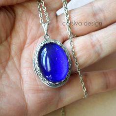 This beautiful locket is adored with a large 18x25 Ruby Red Green glass gem stone. Size: 24x30mm Chain Length: Per Option Qty: 1pc Blue Oval Locket Necklace, Oval Blue Locket Necklace, Blue Personalized Metal Jewelry, Personalized Blue Metal Jewelry, Personalized Blue Jewelry, Nickel-free Sapphire Jewelry Gift, Sapphire Cabochon Oval Jewelry, Nickel-free Sapphire Jewelry As A Gift, Nickel-free Sapphire Jewelry For Gift